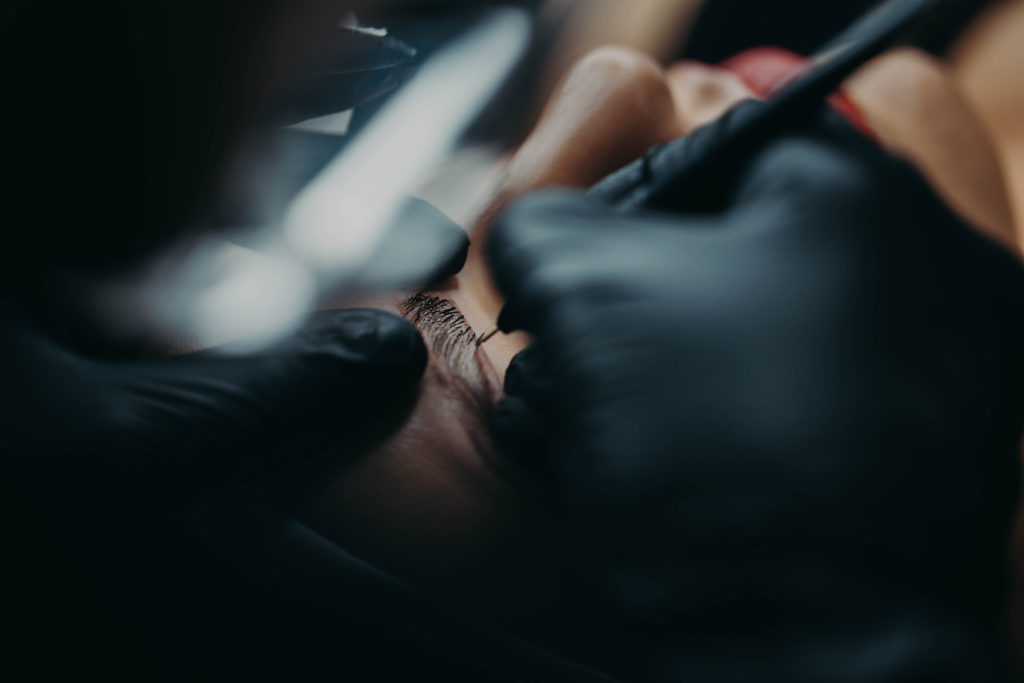 Microblading Master In Black Gloves With A Needle On